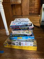 Stack of eight military themed model kit boxes including tanks and infantry from Italeri and Academy brands.