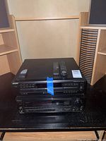 Sony STR-AV770X receiver and Sony CDR-CE335 DVD player stacked, showing top and front views with remote controls on top