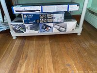 Four opened-boxed plastic model kits on shelf