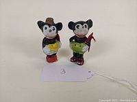 Front view of Mickey and Minnie Mouse bisque porcelain figurines.