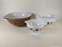 Three Pyrex Cinderella mixing bowls arranged to show pattern and size variation.