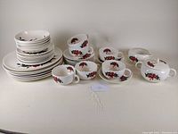 Full set of Crooksville Pottery Iva Lure Line Flamingo Pattern dinnerware including cups, saucers, plates of various sizes, dessert bowls, creamer and sugar bowl, arranged together on flat surface.