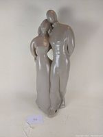 Front view of the Haeger Pottery figurine showing the man and woman strolling arm-in-arm with smooth finish and minimalistic design.