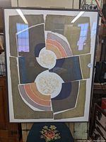 Framed limited edition modernist serigraph poster angled to front, showing abstract geometric and circular designs in muted tones.