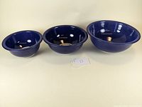 Three blue Pyrex mixing bowls nested side by side showing their outside view