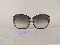 Front view showing large gradient lenses and beige transparent frame.