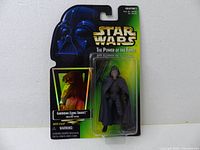 Front view of the sealed 1997 Star Wars Power of the Force Garindan figure in original packaging, showing the figure and card design.