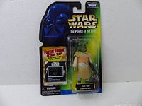 Front view of new in package 1997 Star Wars The Power of the Force Ishi Tib action figure with blaster rifle and Freeze Frame slide in original packaging showing Darth Vader branding and logo.