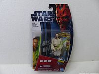 Front view of sealed Star Wars Movie Heroes Qui-Gon Jinn action figure with grappling hook launcher accessory