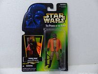 Front view of the Ponda Baba action figure in original green card packaging showing Darth Vader illustration and character photo.