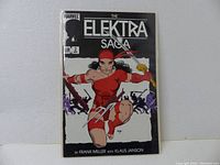 Front cover photo of The ELEKTRA SAGA #2 comic showing character Elektra in red costume in a dynamic pose, clear comic title and issue details.