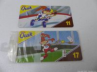 Two Nestle Quik trading cards, numbers 11 and 17, showing cartoon rabbit characters playing hockey and tennis respectively.