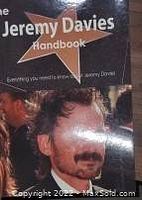 Close-up photo of the autobiography book cover titled 'Jeremy Davies Handbook' with subtitle 'Everything you need to know about Jeremy Davies'.