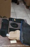 Photo showing wrist braces: blue fabric wrist brace and beige elastic wrist wrap.