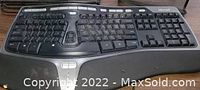 Top view of the used black Microsoft Natural Ergonomic Keyboard 4000 showing the split keyboard layout, upper function keys, and integrated wrist rest.