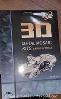 Front view of closed 3D metal mosaic kit box with sports car image.