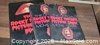 Three vintage Rocky Horror Picture Show fan books stacked, showing wear and title on top book.