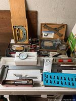 Overview of entire lot showing various measuring tools in foam and on table