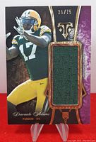 Front view of the 2014 Topps Triple Threads Davante Adams rookie card with visible green fabric patch, card numbered 36/75, and near mint to mint condition.
