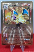 Front of gold metal Charizard card on stand