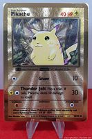 Front of the 2021 Pokémon Ultra Premium Pikachu gold metal card showing Pikachu hologram, attacks, and HP.