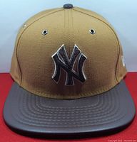 Front view of the brown New York Yankees hat with embroidered logo and darker brown visor.