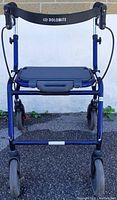 Front view of blue Dolomite roller walker showing wheels, padded seat, and hand brake cables