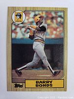 Front of the 1987 Topps Barry Bonds rookie card showing image of Bonds batting for the Pittsburgh Pirates in uniform with yellow helmet.