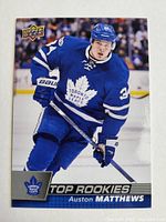 Front of the Auston Matthews rookie card showing the player in Toronto Maple Leafs jersey and 'Top Rookies' label.
