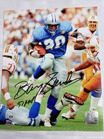 Signed 8x10 color photo of Barry Sanders in Lions uniform running with football, signed "Barry Sanders 97 MVP".