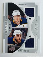Front of the card showing both players with jersey patches and serial number.