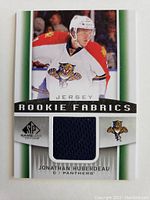Front of the Jonathan Huberdeau Rookie Fabrics NHL hockey card showing player's image, team logo, and embedded jersey fabric patch.