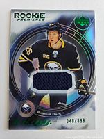 Front of the card showing Rasmus Dahlin in Sabres jersey with embedded fabric swatch and card number 048/399.