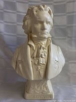 Front view of the Beethoven bust sculpture showing detailed facial features, attire, and pedestal base with inscription.