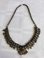 Full view of vintage heavy metal necklace with pendant and chain.