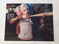 Color photo of Margot Robbie as Harley Quinn holding a baseball bat, character image print in 8x10 size.