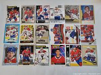 Full image showing all 22 Montreal Canadiens hockey cards fanned out in plastic sleeves on a flat surface.