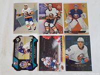 Six New York Islanders themed hockey cards showing various players in action, mix of rookie and star cards in good condition