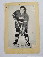 Black and white photo of 1960's Red Kelly Detroit Red Wings hockey card with wear and corner damage