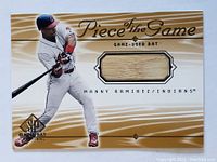 Front of the Upper Deck trading card showing Manny Ramirez in batting stance with embedded piece of game-used bat.