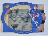 Front of the Wayne Gretzky SPX Spectrum insert card showing player in New York Rangers uniform with blue and gold design and secondary blurred background image.