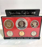 Front view of the 1979 US proof coin set in plastic casing with red background, showing all six coins face obverse side.