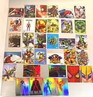 Front view of all 34 Marvel Preziosi Collection cards laid out in rows showing variety of characters and holographic shine on some cards.