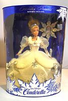 Full front view of the Cinderella Holiday Princess doll in original packaging showing the doll, box design, and holiday ornament.