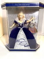 Front of boxed Millennium Princess Barbie doll in special edition packaging, showing the doll in royal blue and silver gown with Millennium Keepsake beside her.