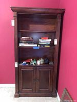 Front view showing three open shelves and base cabinet with two doors