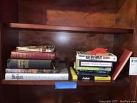 Books on a shelf including Beatles Anthology, Bibles, self-help and reference books.