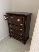 Three-quarter view with top drawer open showing finish and hardware