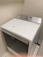 Front perspective view showing white enamel body, stainless steel control panel, black tinted glass door