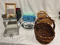 Overview of baskets and storage containers in the lot arranged on a white cloth background.